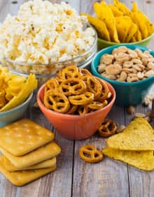 chips, biscuits, popcorn snacks in bowls