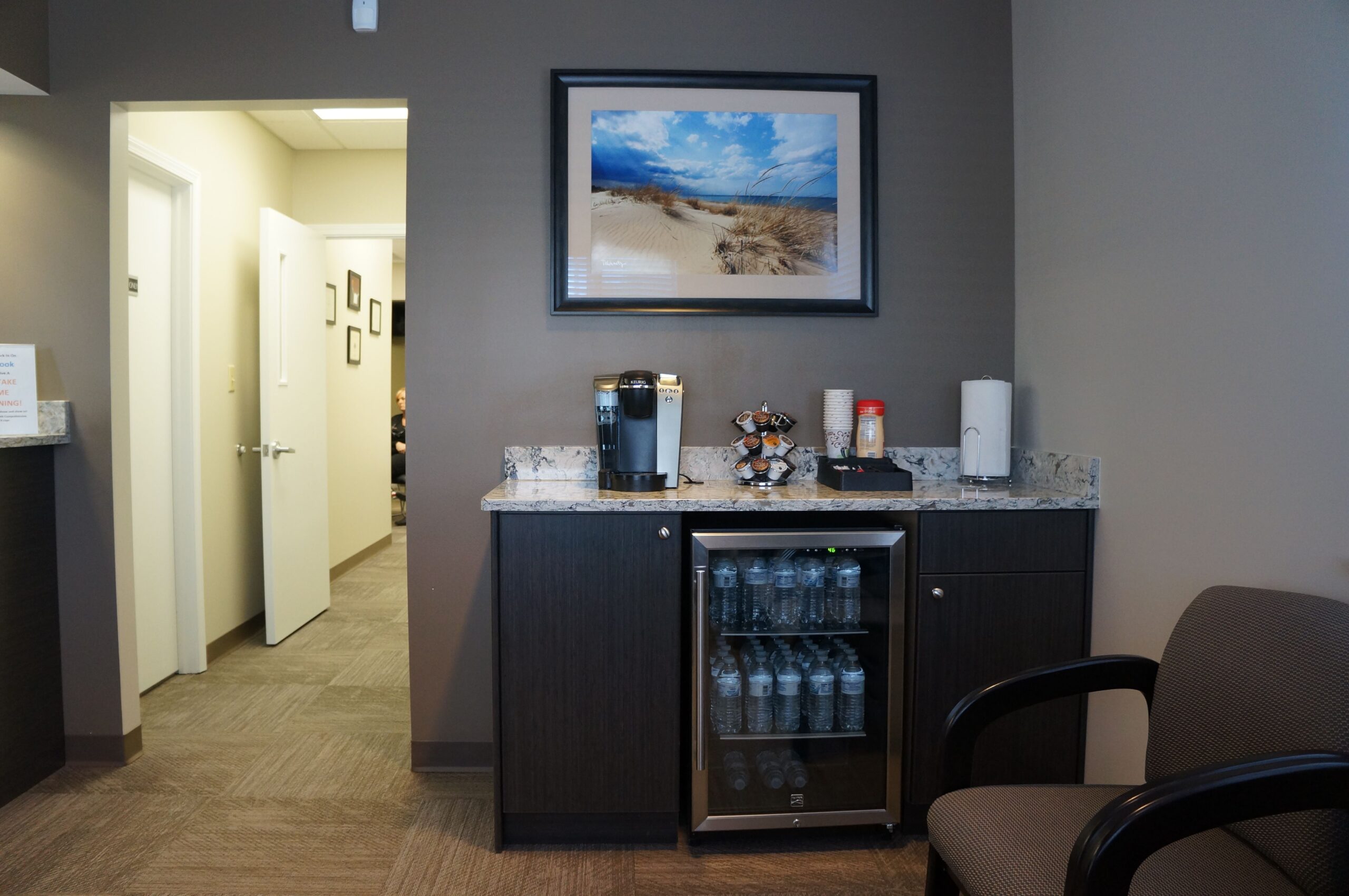 Self-service coffee and water station in a healthcare facility waiting area, the kind of smaller service point alongside cafeteria and nursing-station coffee programs