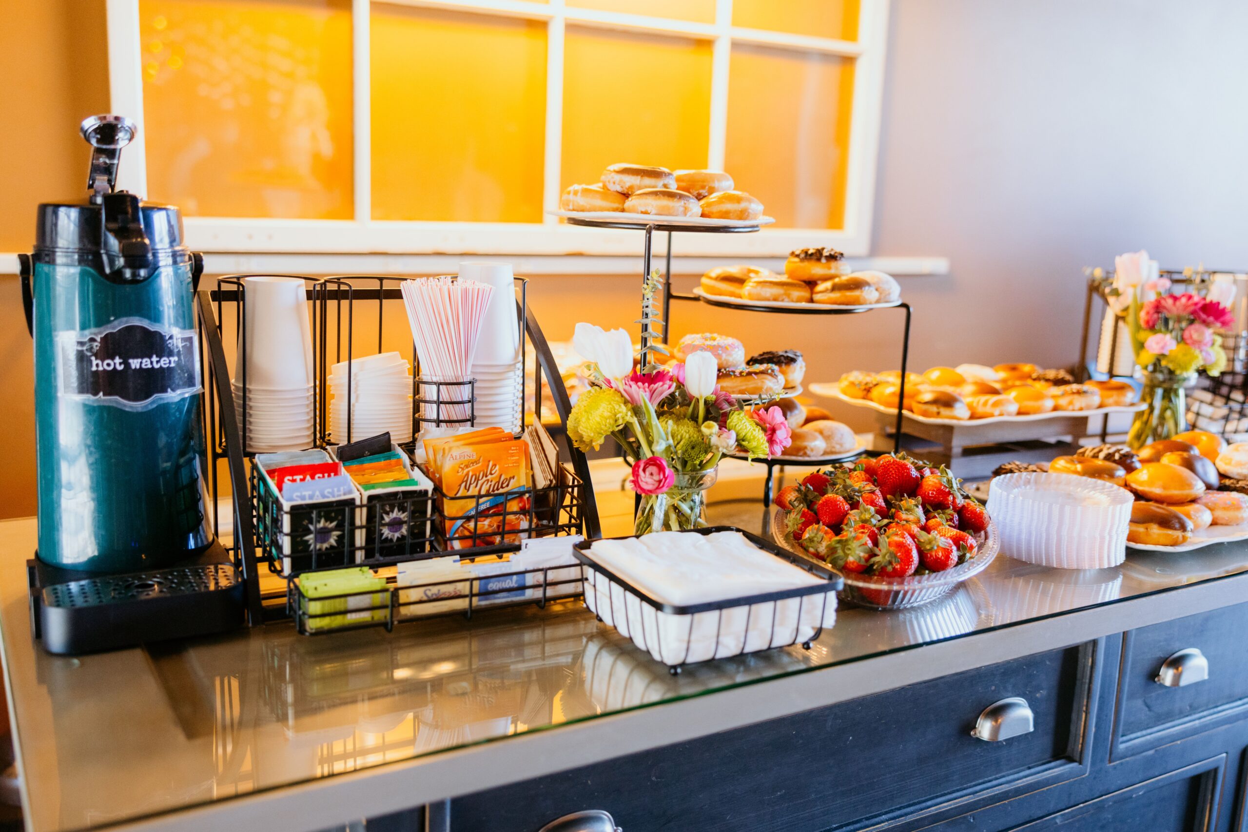 Hotel coffee and breakfast station with airpot dispenser and supplies, matching the breakout-room beverage service the article describes.