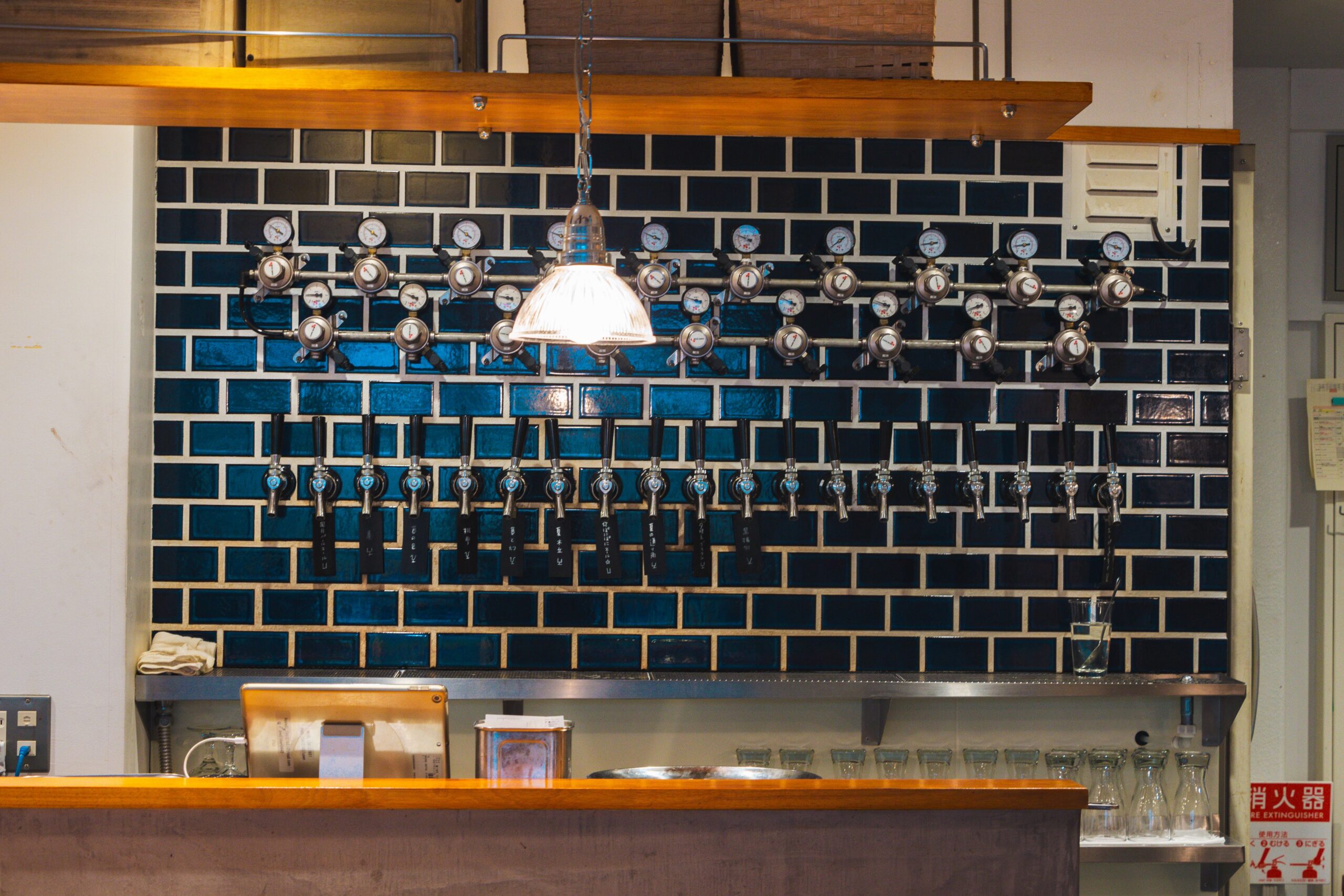 Draft beer regulators and tap faucets on a bar wall, illustrating the core components of a commercial draft system.