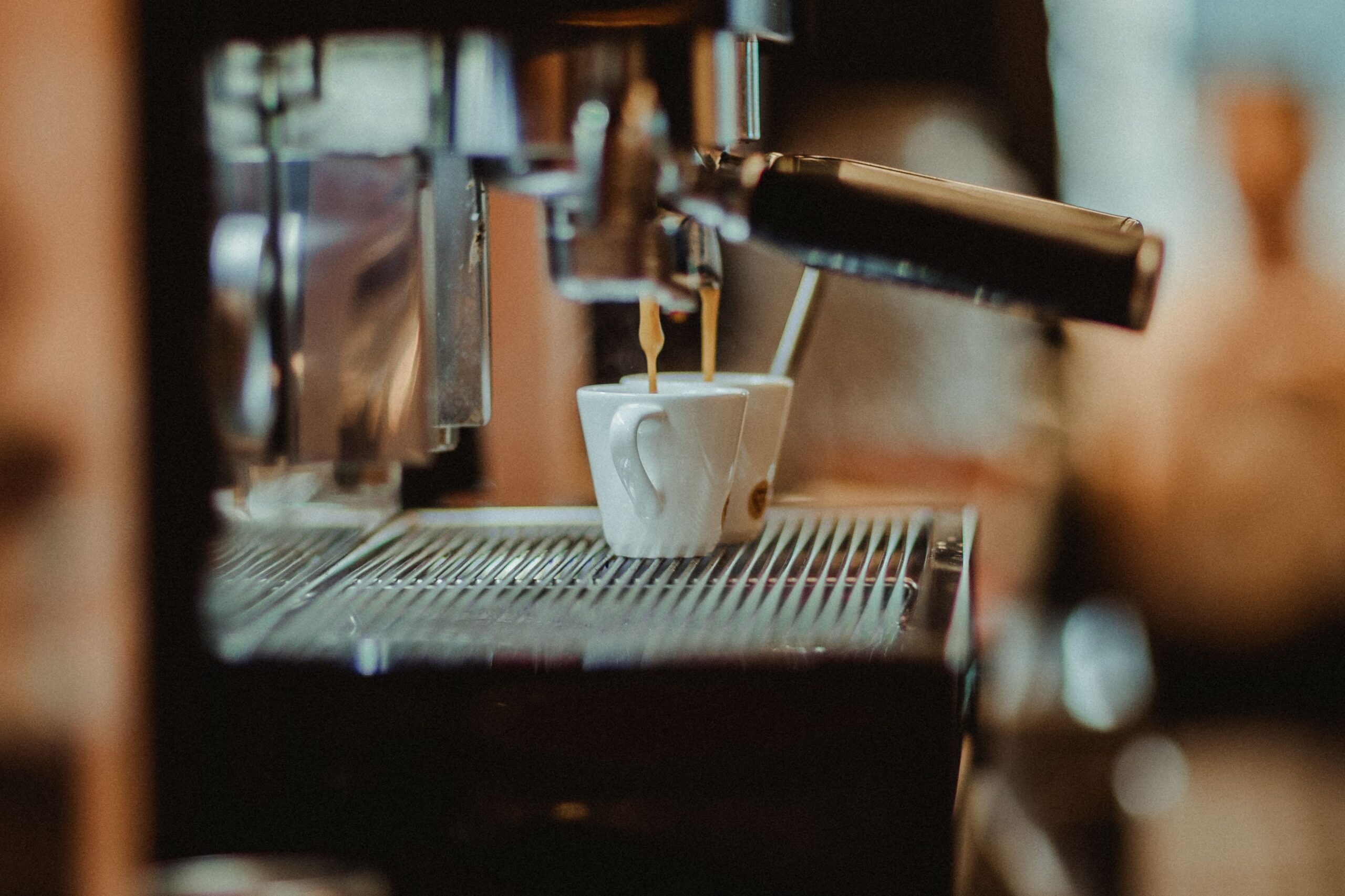 Commercial espresso machine preparing coffee as part of a hotel beverage service program.