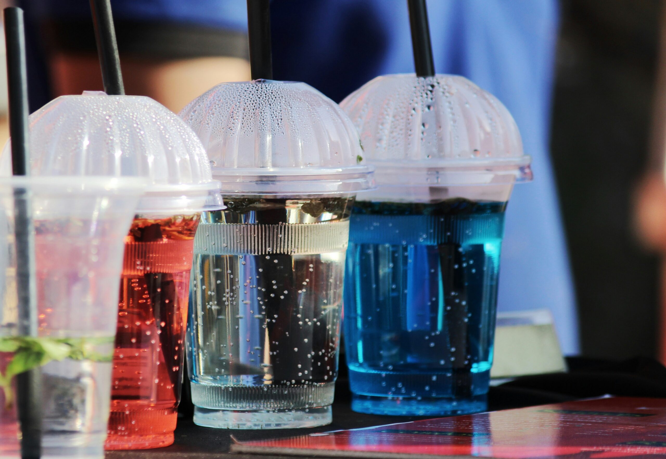 Colorful carbonated drinks with straws, representing the fountain beverage output covered in this troubleshooting guide.