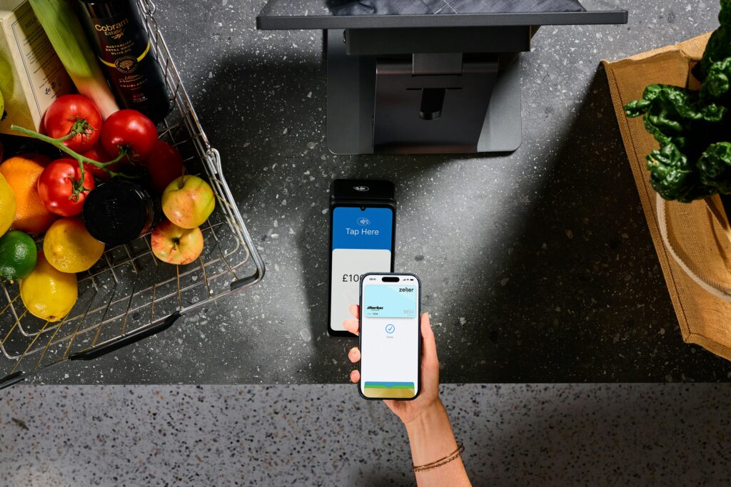 Contactless mobile payment at a self-checkout terminal, illustrating the cashless payment technology used in unattended retail micro markets.