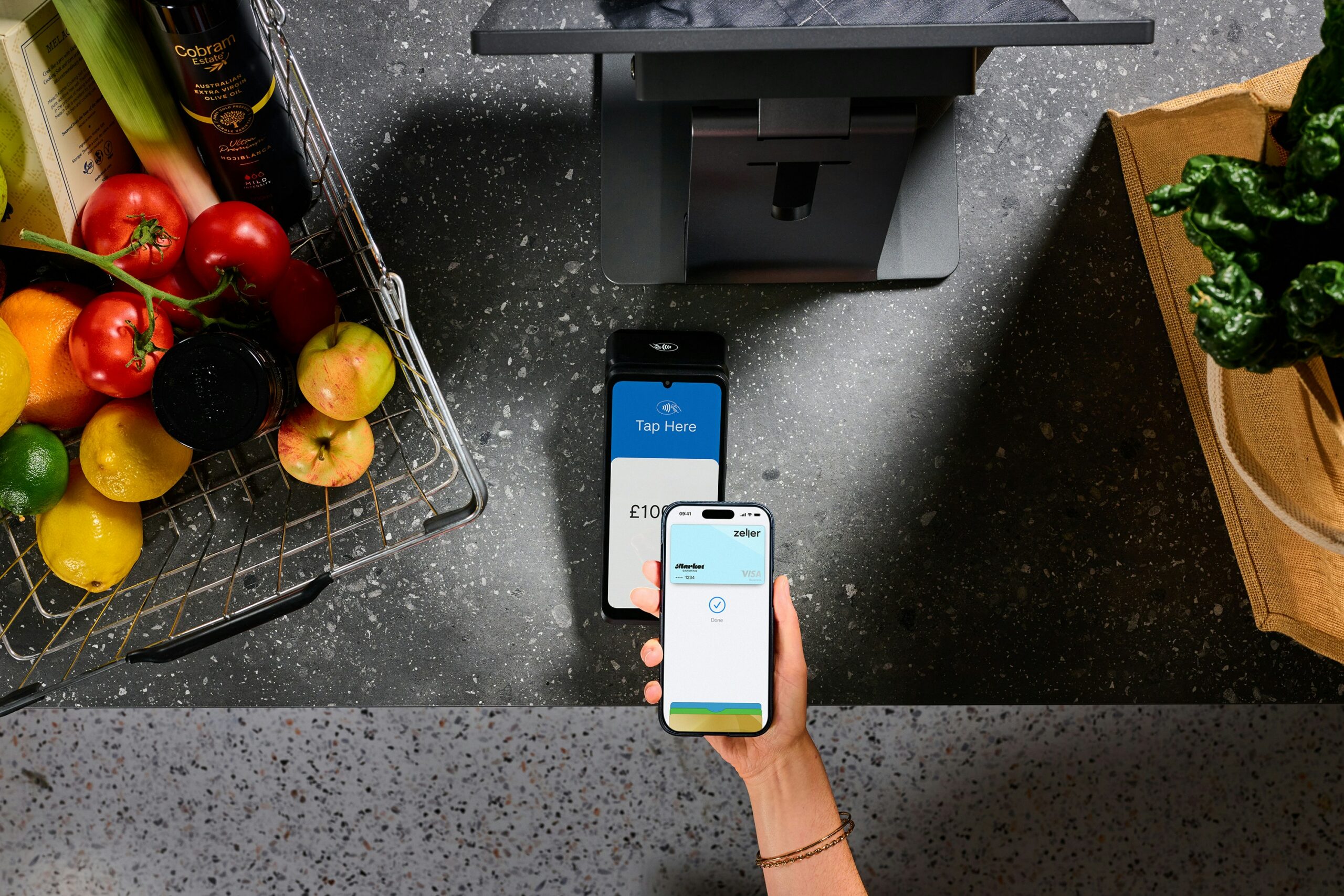 Contactless mobile payment at a self-checkout terminal, illustrating the cashless payment technology used in unattended retail micro markets.